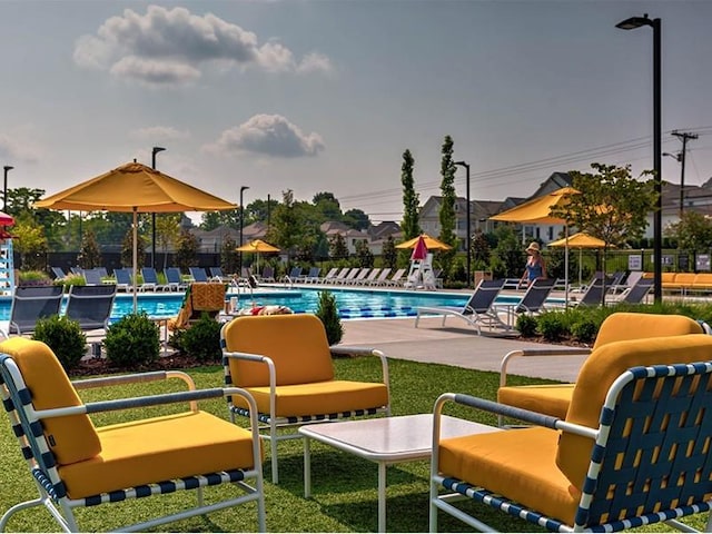 community pool featuring fence and a patio