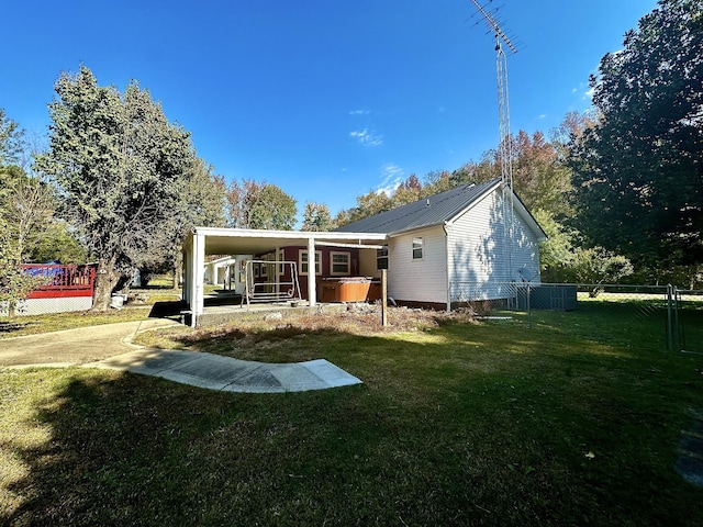 273 Chapel Rd, New Johnsonville, TN 37134 - back of house with metal roof, fence, and a lawn