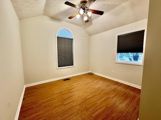 273 Chapel Rd, New Johnsonville, TN 37134 - spare room featuring a textured ceiling, visible vents, baseboards, wood finished floors, and vaulted ceiling