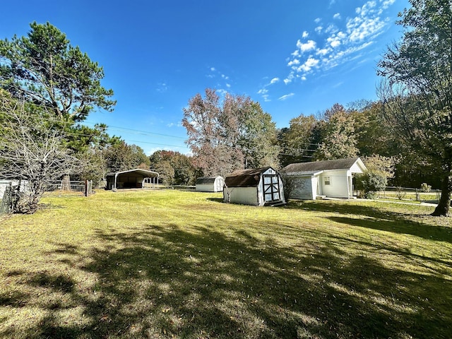 273 Chapel Rd, New Johnsonville, TN 37134 - view of yard featuring an outdoor structure, a storage unit, fence, and a detached carport