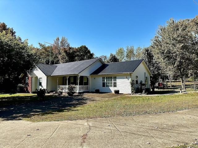 273 Chapel Rd, New Johnsonville, TN 37134 - ranch-style house with metal roof, a front yard, covered porch, and driveway