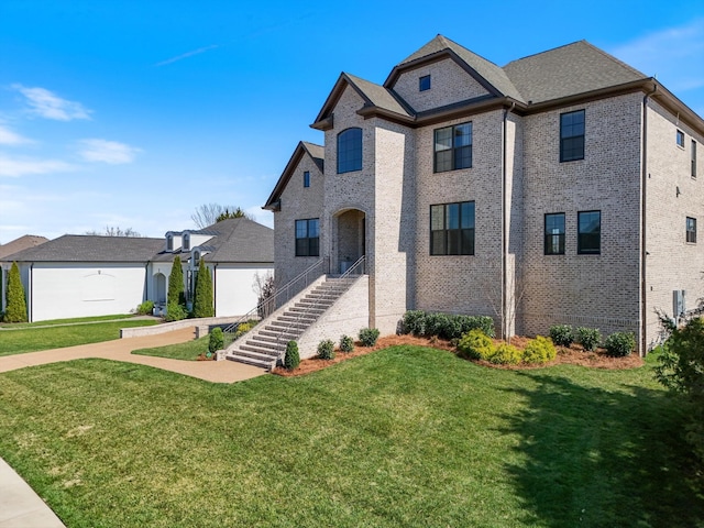 1428 Boardwalk Pl, Gallatin, TN 37066 - french country inspired facade with a front lawn and brick siding