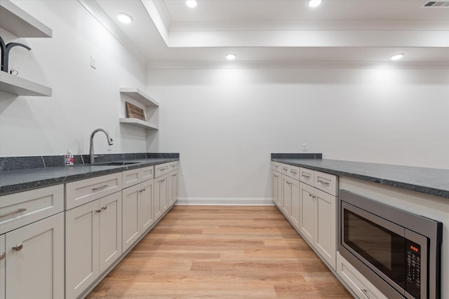 1428 Boardwalk Pl, Gallatin, TN 37066 - kitchen featuring open shelves, recessed lighting, stainless steel microwave, a sink, and light wood-style flooring