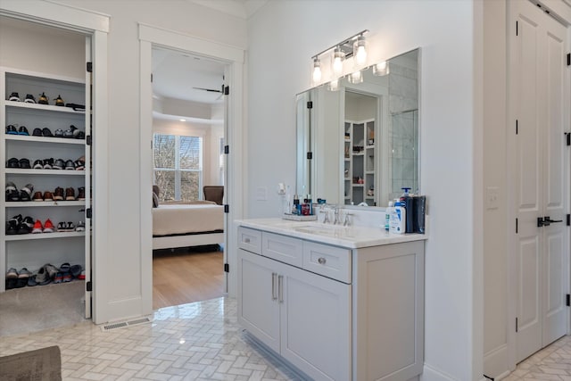 1428 Boardwalk Pl, Gallatin, TN 37066 - full bathroom featuring vanity, a spacious closet, connected bathroom, brick floor, and visible vents