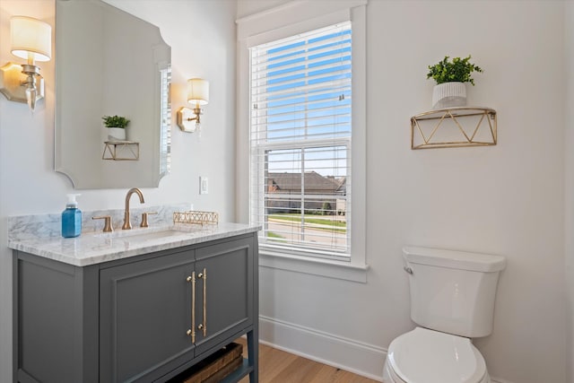 1428 Boardwalk Pl, Gallatin, TN 37066 - bathroom with baseboards, toilet, vanity, and wood finished floors