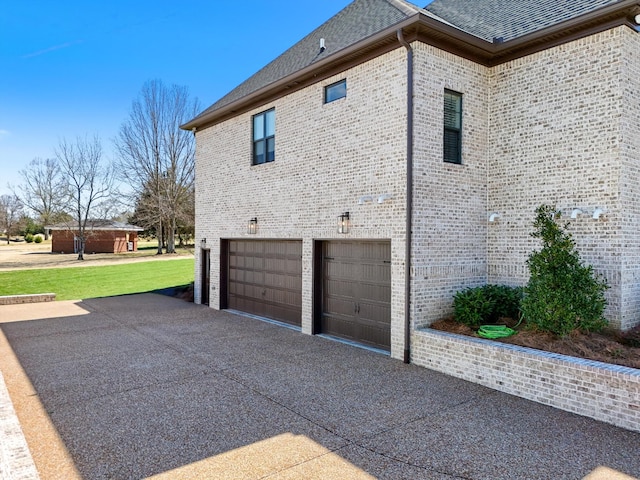 1428 Boardwalk Pl, Gallatin, TN 37066 - view of property exterior with brick siding, a garage, driveway, and a shingled roof