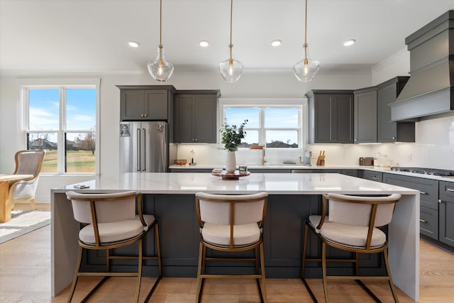 1428 Boardwalk Pl, Gallatin, TN 37066 - kitchen with a wealth of natural light, a kitchen island, tasteful backsplash, gray cabinetry, and stainless steel appliances