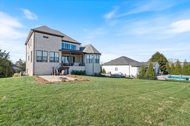 1428 Boardwalk Pl, Gallatin, TN 37066 - back of house featuring a lawn, an outdoor pool, a patio area, and brick siding