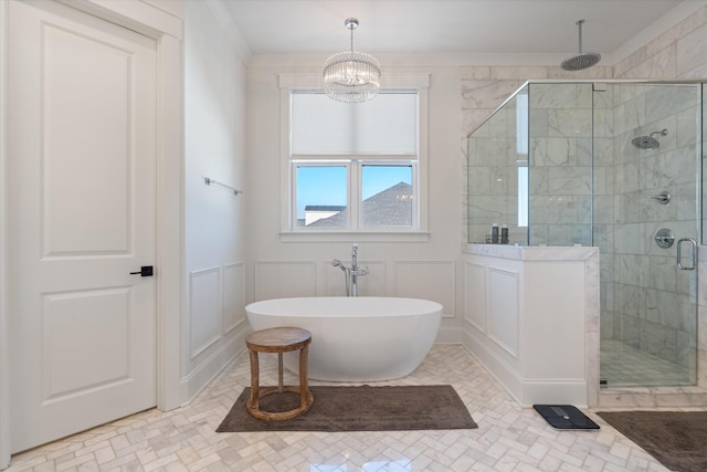 1428 Boardwalk Pl, Gallatin, TN 37066 - bathroom with a stall shower, a wainscoted wall, a notable chandelier, a decorative wall, and a freestanding bath