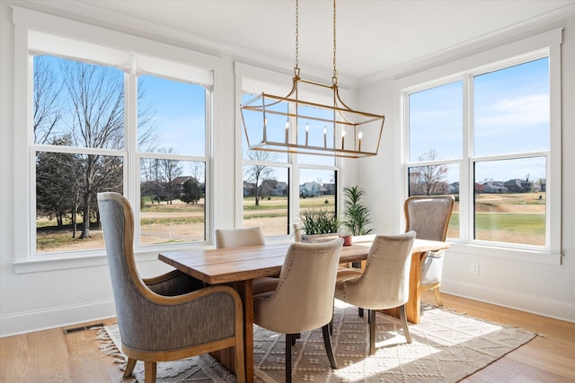 1428 Boardwalk Pl, Gallatin, TN 37066 - dining area with visible vents, crown molding, light wood-style floors, and an inviting chandelier