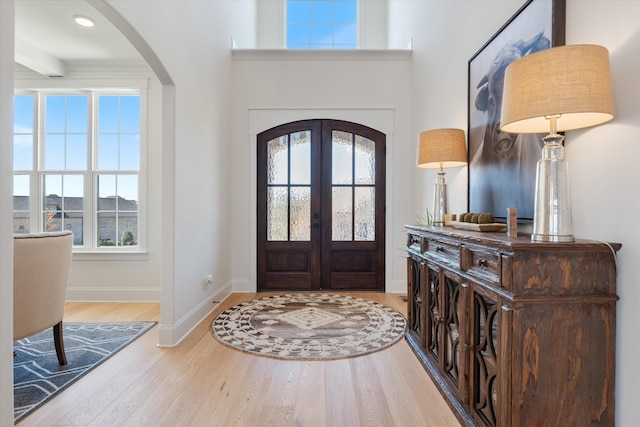 1428 Boardwalk Pl, Gallatin, TN 37066 - foyer featuring arched walkways, baseboards, wood finished floors, and french doors