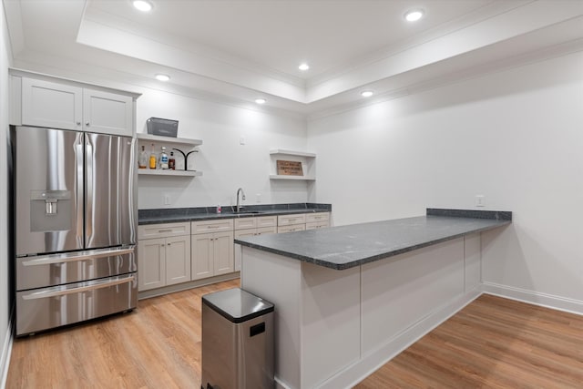 1428 Boardwalk Pl, Gallatin, TN 37066 - kitchen featuring a tray ceiling, light wood-style flooring, stainless steel refrigerator with ice dispenser, and open shelves