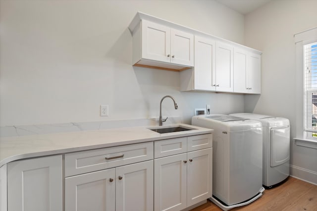 1428 Boardwalk Pl, Gallatin, TN 37066 - laundry room with light wood-style flooring, a sink, cabinet space, and separate washer and dryer