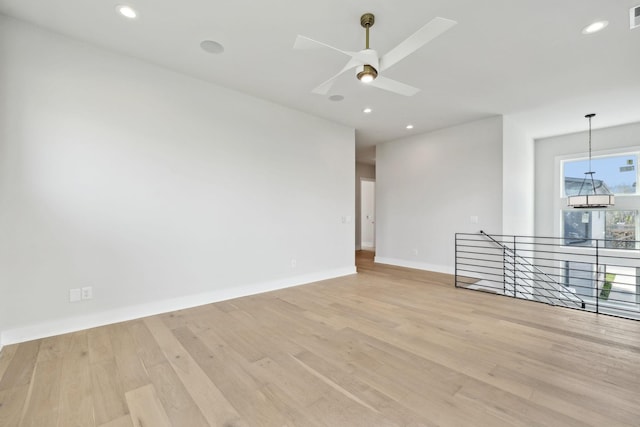 empty room featuring recessed lighting, light wood finished floors, visible vents, baseboards, and ceiling fan