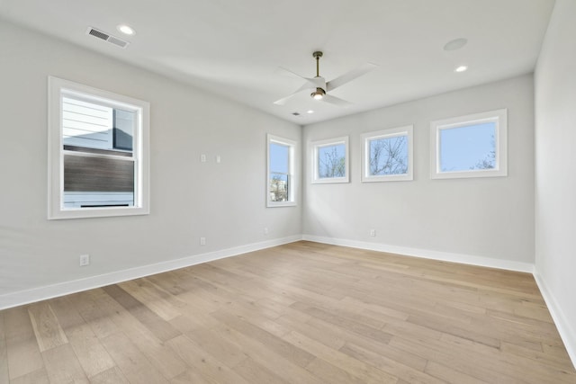 empty room featuring baseboards, visible vents, recessed lighting, light wood-style floors, and a ceiling fan