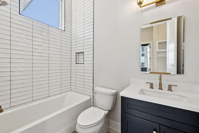bathroom featuring baseboards, a wealth of natural light, toilet, and vanity