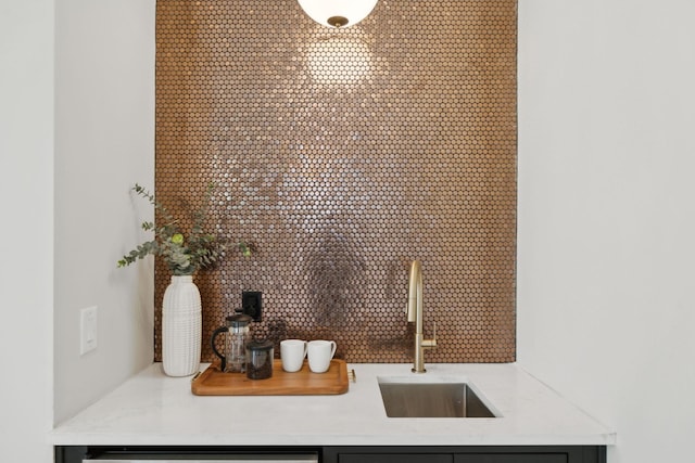 details featuring a community bar, light countertops, and a sink
