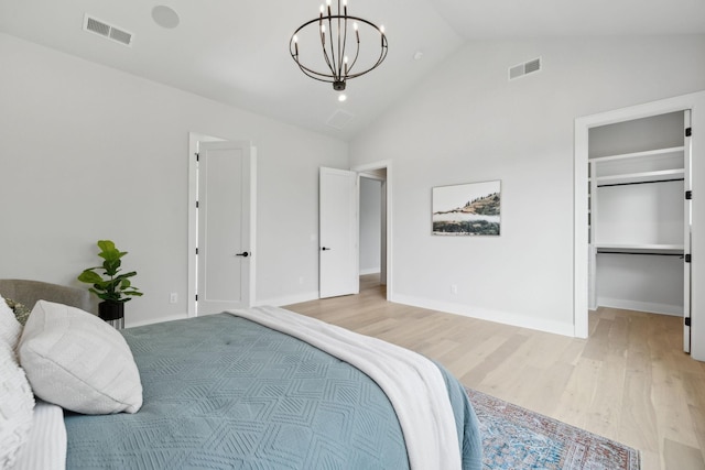 bedroom with a notable chandelier, visible vents, and light wood-type flooring