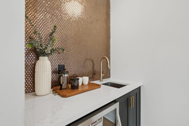 bar featuring bar area, backsplash, and a sink