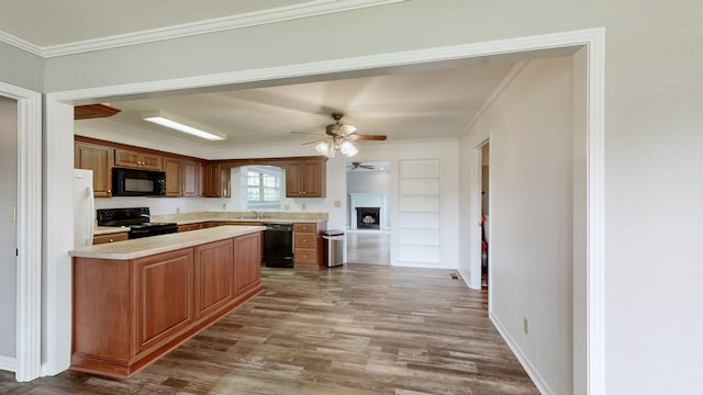 411 Whaley St, Smithville, TN 37166 - kitchen with black appliances, ornamental molding, light countertops, a sink, and wood finished floors