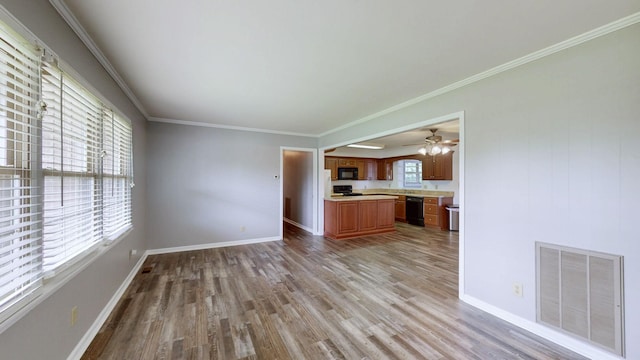 411 Whaley St, Smithville, TN 37166 - unfurnished living room with light wood finished floors, baseboards, and crown molding