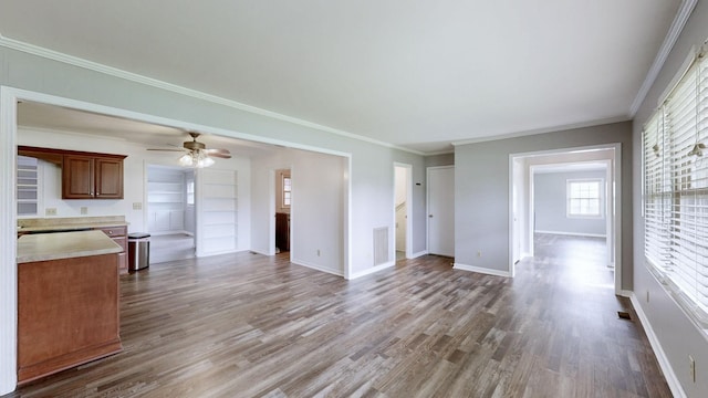 411 Whaley St, Smithville, TN 37166 - unfurnished living room with wood finished floors, a ceiling fan, baseboards, and crown molding