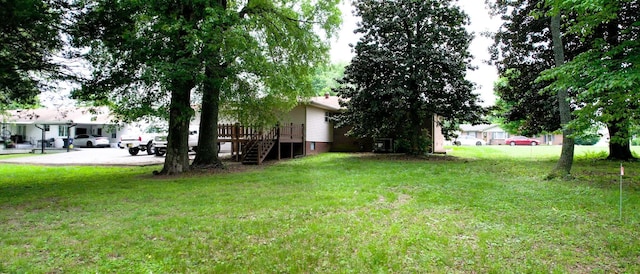 411 Whaley St, Smithville, TN 37166 - view of grassy yard with a deck and stairway