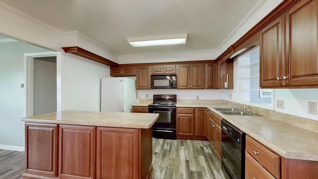 411 Whaley St, Smithville, TN 37166 - kitchen with black appliances, a sink, light wood-style flooring, a kitchen island, and crown molding