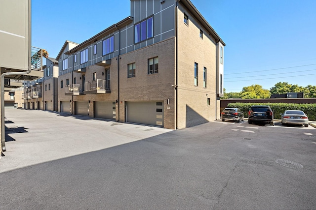 view of property featuring an attached garage and a residential view