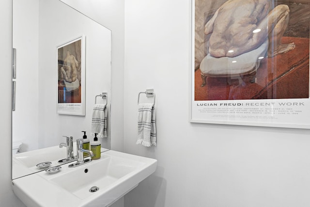 half bath featuring a sink