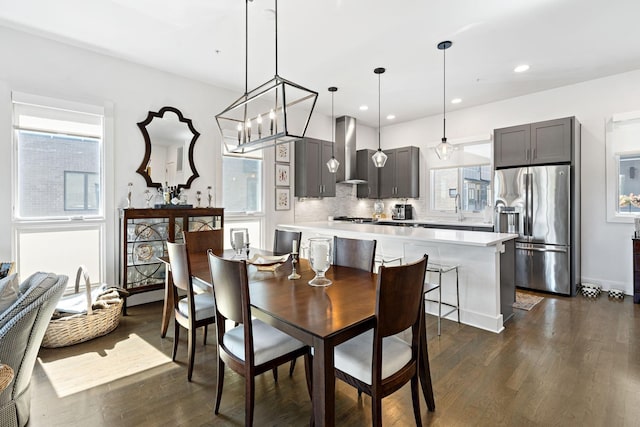 dining area featuring recessed lighting, a healthy amount of sunlight, and dark wood finished floors