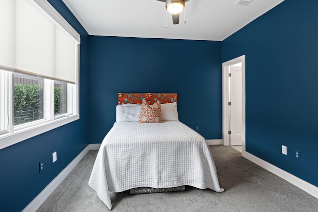 bedroom with baseboards, visible vents, carpet flooring, and a ceiling fan