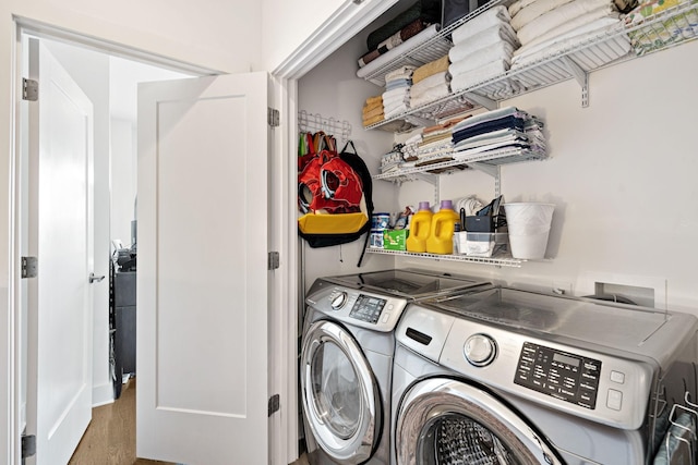 clothes washing area featuring washer and clothes dryer and laundry area
