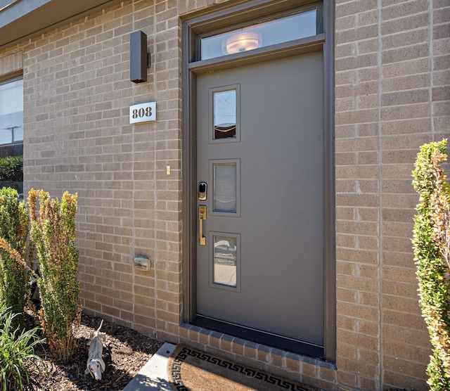 entrance to property with brick siding