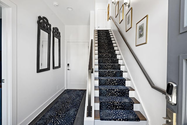 stairway featuring baseboards