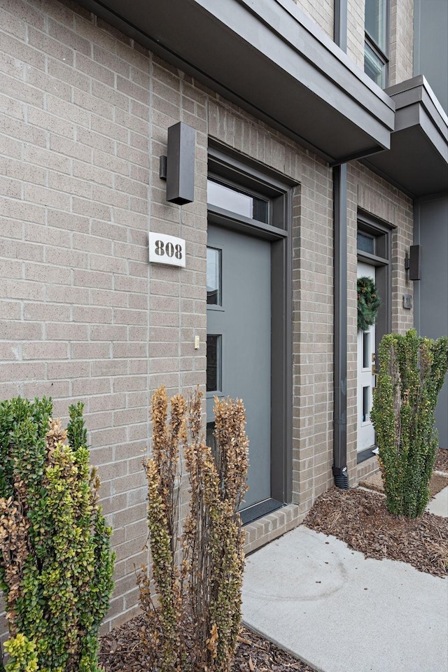 property entrance featuring brick siding
