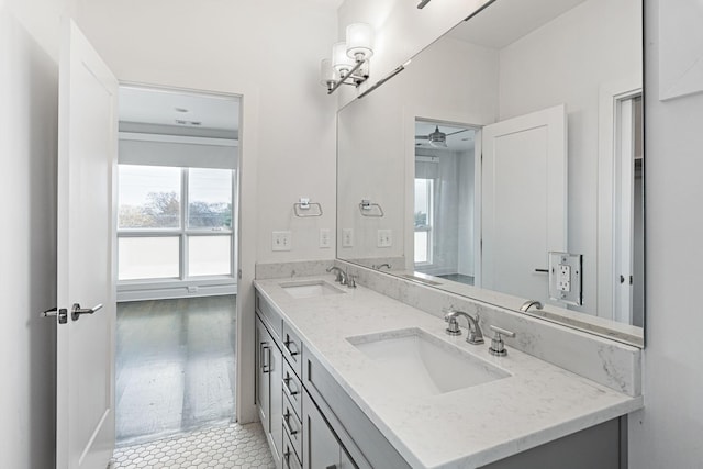 bathroom featuring double vanity, a sink, and ceiling fan