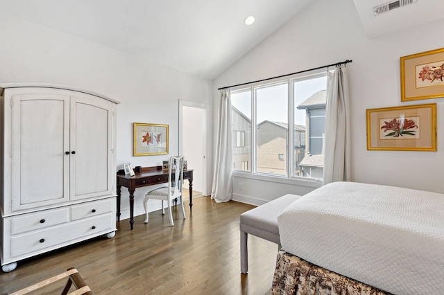 bedroom featuring dark wood-type flooring, baseboards, vaulted ceiling, and visible vents