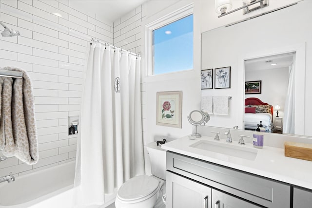 ensuite bathroom with ensuite bath, toilet, shower / tub combo, and vanity