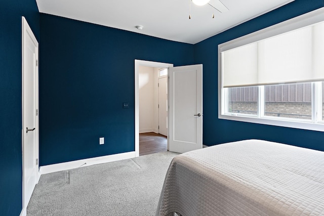 bedroom featuring baseboards, carpet flooring, and a ceiling fan