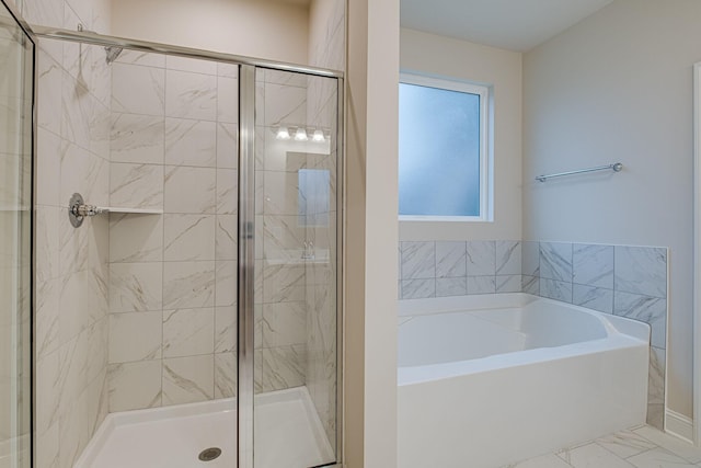 bathroom with a garden tub, a shower stall, and marble finish floors