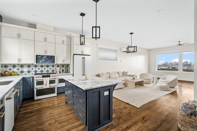 3118 Trevor St, Nashville, TN 37209 - kitchen featuring open floor plan, high end appliances, blue cabinetry, and backsplash