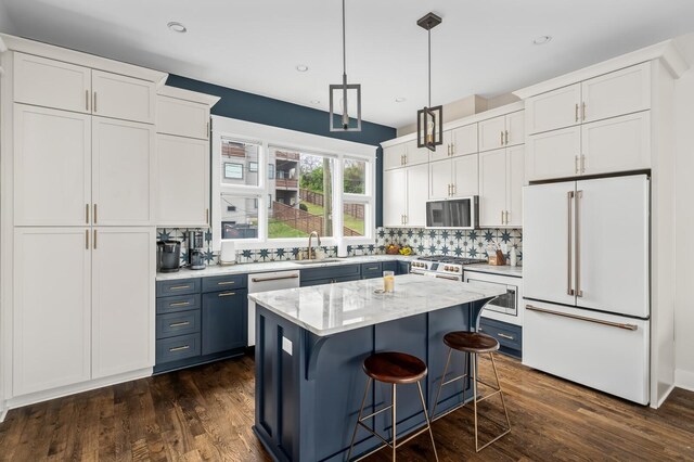3118 Trevor St, Nashville, TN 37209 - kitchen with a kitchen bar, a sink, white appliances, and white cabinets