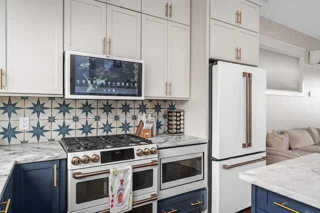 3118 Trevor St, Nashville, TN 37209 - kitchen featuring stainless steel appliances, white cabinetry, blue cabinets, and backsplash