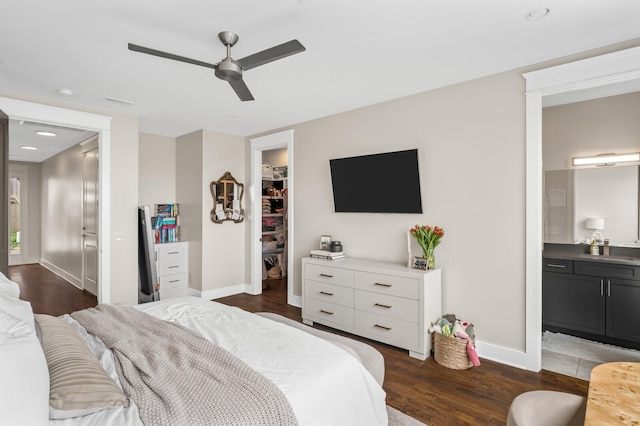 3118 Trevor St, Nashville, TN 37209 - bedroom with a closet, baseboards, a spacious closet, connected bathroom, and dark wood-type flooring