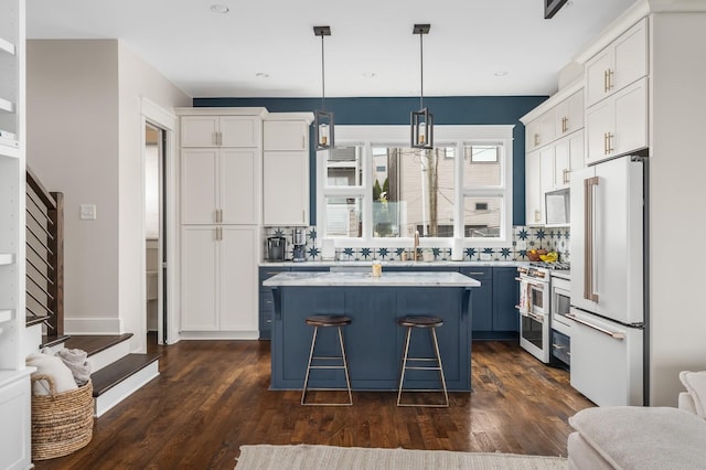 3118 Trevor St, Nashville, TN 37209 - kitchen with white cabinets, a center island, light countertops, and high end appliances