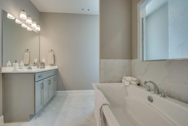 3021 Fanshaw Rd, Smyrna, TN 37167 - bathroom featuring visible vents, marble finish floor, vanity, and a bathing tub