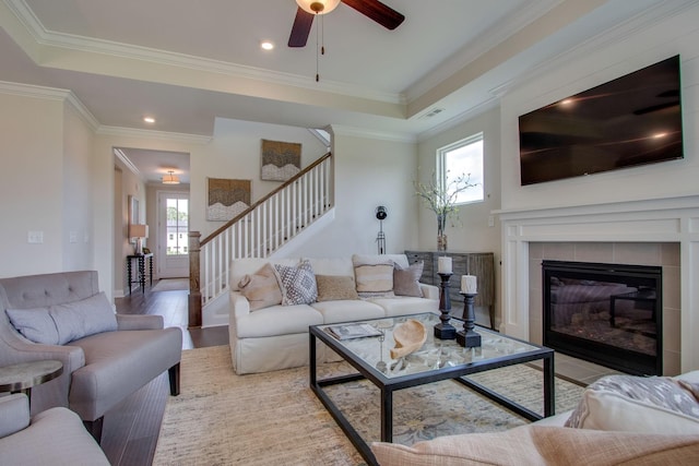 3021 Fanshaw Rd, Smyrna, TN 37167 - living area featuring stairway, crown molding, a ceiling fan, a tile fireplace, and visible vents
