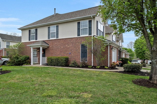 traditional home featuring brick siding and a front lawn