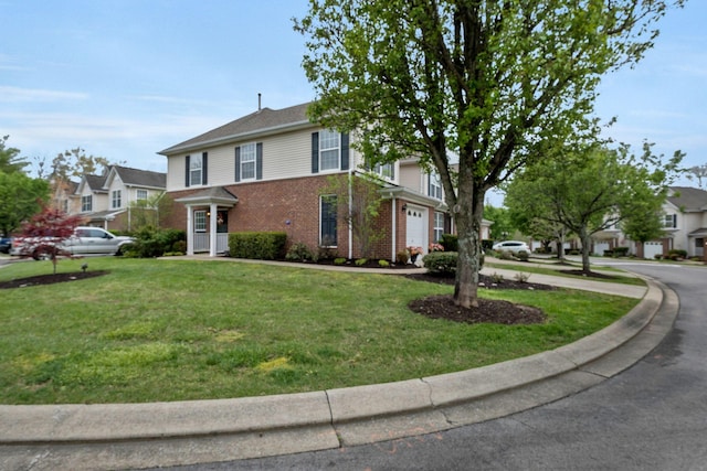 traditional-style home featuring brick siding, an attached garage, a residential view, and a front lawn
